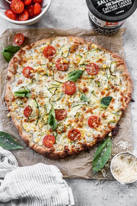 Cottage Cheese Pizza is the summer pie you never knew you needed. With a creamy, tangy cottage cheese and sharp provolone base and a delicate shaved zucchini, sweet corn and cherry tomato topping, this veggie forward pizza is truly a winner. Cottage Cheese Pizza, Tomato Topping, Pizza Cooking, Cheese Crust Pizza, Summer Pie, Favorite Recipes Dinner, Pizza Recipes Homemade, Savory Appetizer, Cherry Tomato