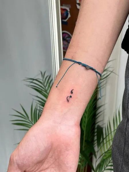 35 Best Meaningful Semicolon Tattoo Ideas - Tattoo Pro #tattooideas #tattooideasforgirls #tattooideasforguys #womenstattoo #tattoodesign #tattoostyle Eight Note Tattoo, Semi-colon Tattoo With Music Note, Music Note And Semicolon Tattoo, Paw Print Music Note Tattoo, Cute Tattoos Music, Music And Semicolon Tattoo, Rest Note Tattoo, Music Tattoo Wrist, Music Simple Tattoo