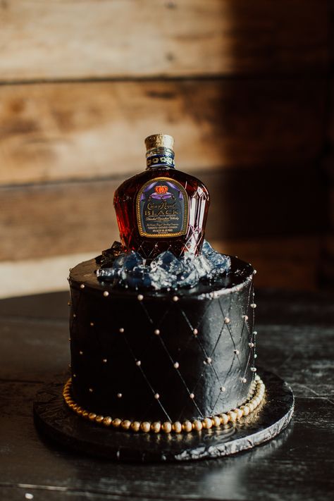 A fun and unique grrom's cake idea topped with a whiskey bottle Grooms Cake Whiskey, Mens Wedding Cake, Grooms Cakes Ideas, Groomsmen Cake Ideas, Black Country Wedding, Grooms Cake Ideas Unique, Groom Cake Ideas, Grooms Cake Hunting, Funny Grooms Cake