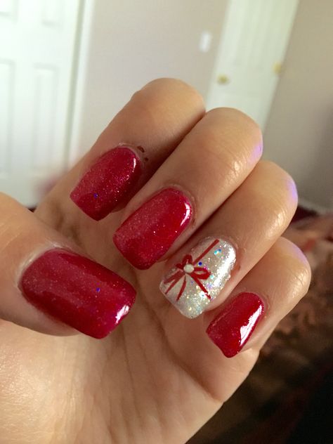 Cute nails, Christmas nails, acrylic, gel, shilac, red, silver, sparkly, glitter, ringer finger design, bow, rhinestone Sparkly Christmas Nails, Christmas Nails Glitter, Finger Design, Red Christmas Nails, Squoval Nails, Holiday Nail Designs, Christmas Nails Easy, Christmas Gel Nails, Cute Christmas Nails