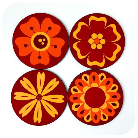 "Add a blast of 70s vintage flair to your coffee table with our Retro Flowers Coasters in classic 1970s Oranges and Browns. High gloss with super saturated colours and full on retro attitude, these coasters are perfect for funky retro and boho homes .... and they make fabulous gifts for retro freaks!  DETAILS: *Set of four round 70s inspired flower coasters  *Made from melamine on certified FSC hardboard *Diameter: 9cm | 3.5\"  *Gorgeous saturated colours *High Gloss finish *Hardwearing and Easy Wipe Clean! *Heat, Scratch & Fade resistant *Original Retro Design - printed by hand in our Bristol studio in the UK *Gift wrapped as standard We have many more cool 70s items in our store!  MADE TO MATCH! We offer a bespoke colour-match service, get any of our designs to match your own home decor Retro Coasters, Boho Homes, 70s Flowers, Flower Coasters, 70s Design, Orange Drinks, Decor Color Schemes, Retro Fan, Floral Home Decor