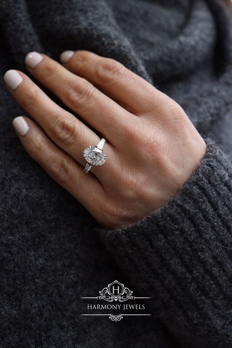 #ovaldiamondring #ovaldiamondengagementring #diamondengagementring #londonjewellery #custommade #harmonyjewelsldn Oval Diamond With Baguette Side Stones, Oval Tapered Baguette Engagement Ring, Oval With Tapered Baguettes, Oval Baguette Engagement Ring, Oval With Baguettes Ring, Oval Engagement Ring With Baguettes, 2ct Oval Engagement Ring, White Gold Oval Engagement Ring, Tapered Engagement Ring