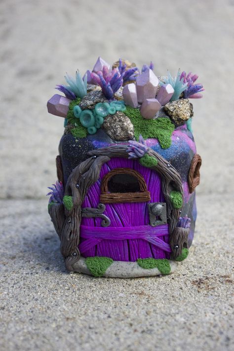 This galaxy-inspired fairy house is made from polymer clay but also includes real mica stones on the "roof" that I gathered myself. I love how they look next to the faux crystals and alien landscape I created. This is the perfect home for spacey fairies! Polymer Clay Fairy House Diy, Polymer Clay Stash Jar, Clay Fairy House Diy, Fairy House Clay, Polymer Clay Jar, Polymer Clay Fairy House, Clay Fairy Garden, Fairy Clay, Alien Landscape