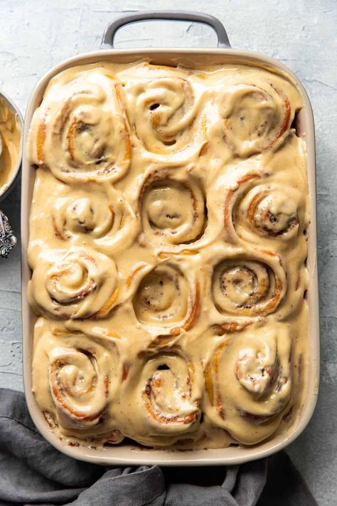 You will love these warm pumpkin cream cheese cinnamon rolls! They are perfect for fall. They boast swirls of fluffy, soft cinnamon dough with luscious, pumpkin cream cheese frosting on top. Best Pumpkin Cinnamon Rolls, Ambitious Kitchen Cinnamon Rolls, Pumpkin Cheesecake Cinnamon Rolls, Fall Cinnamon Rolls Aesthetic, Gourmet Cinnamon Rolls Recipes, Pumpkin Sweet Rolls, Grinch Cinnamon Rolls, Fancy Cinnamon Rolls, Fall Cinnamon Rolls