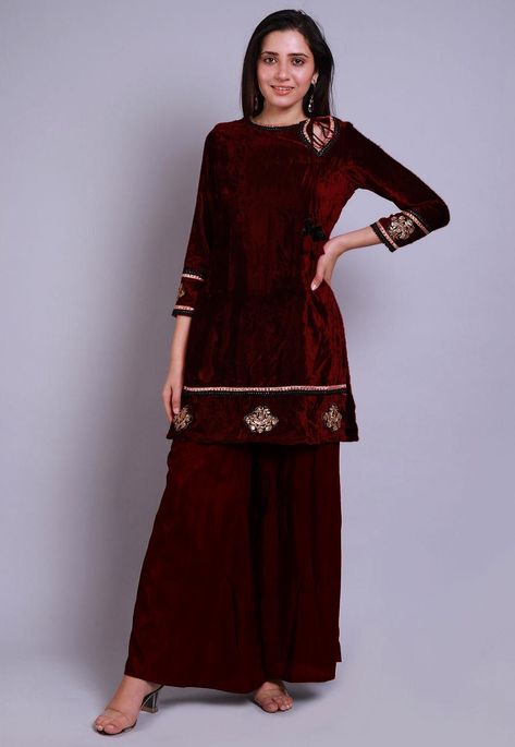 Velvet Straight Kurti in Maroon This Readymade attire with Cotton Lining is Enhanced with Tassels, Zari, Sequins and Lace Border Work and is Crafted in Keyhole Neck and Quarter Sleeve Available with a Shantoon Palazzo in Maroon Do note: Accessories shown in the image are for presentation purposes only and length may vary upto 2 inches.(Slight variation in actual color vs. image is possible). Velvet Frock Design, Velvet Frock, Fancy Maxi Dress, Casual Bridal Dress, Velvet Suit Design, New Dress Pattern, Velvet Dress Short, Straight Kurti, Velvet Dress Designs