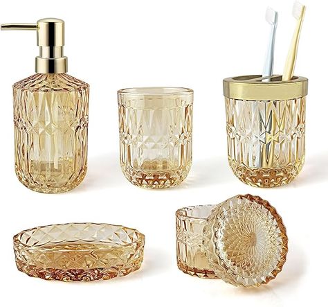 5pcs Clear Golden Glass Bathroom Accessories: 1 Soap Dispenser, 1 Tumbler, 1 Soap Dish, 1 Toothbrush Holder, 1 Jar for cotton swab or cotton pads You can use these items together in your bathroom counter, your restroom, or you can use individual piece, such as tumbler for makeup tools, razor or pens, dispenser for lotion, soap and more. Modern crystal glass accessories are made from thick and durable glass, providing a luxurious and sturdy feel. Vintage Gold Bathroom Accessories, Bath Salt Decor, Gold Bathroom Accents, Bathroom Decor Yellow, Bathroom Sets Bath Accessories, Shower Goals, Yellow Bathroom Accessories, Black Bathroom Accessories Set, Gold Bathroom Set