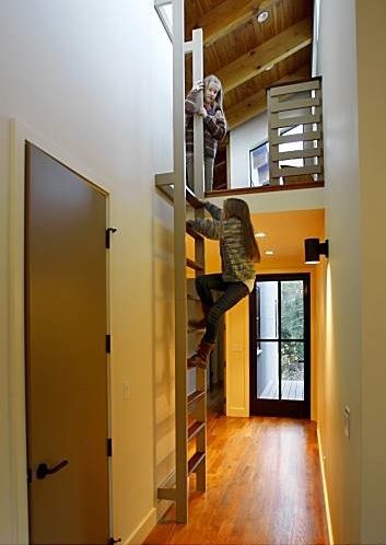 Berkeley-based designer Gustave Carlson used reclaimed teak flooring, custom powder-coated aluminum windows and doors from Bonelli Windows & Doors in S Attic Game Room, Attic Wardrobe, Attic Lighting, Slanted Walls, Aluminium Windows And Doors, Loft Stairs, Small Attic, Attic Ideas, Loft Ladder