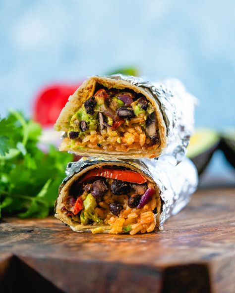 The ultimate vegan burrito! A flavor-packed plant based lunch or dinner idea, it's stuffed with Mexican rice, seasoned black beans and peppers, and avocado. #vegan #veganburrito #burritorecipe #burritos #mexican #plantbased #healthyrecipe Seasoned Black Beans, Vegan Burritos, Best Vegan Chili, Vegan Fajitas, Vegan Enchiladas, A Couple Cooks, Vegan Queso, Authentic Mexican Food, Traditional Mexican Dishes