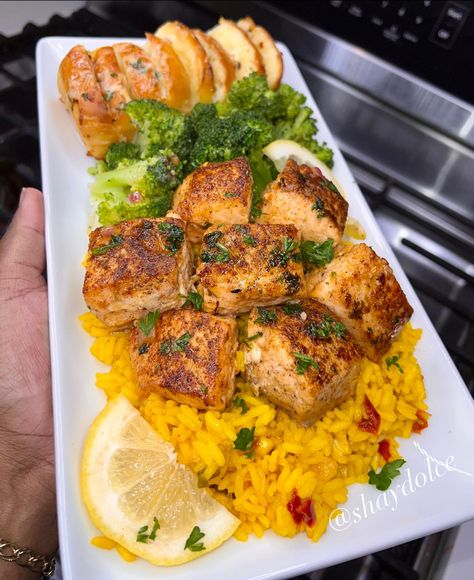 Shay Dolce - Garlic Butter Salmon Bites over Yellow Rice,... Yellow Rice Meals, Garlic Butter Salmon Bites, Rice Meals, Rice Broccoli, Salmon Bites, Garlic Butter Salmon, Butter Salmon, Soul Food Dinner, Yellow Rice