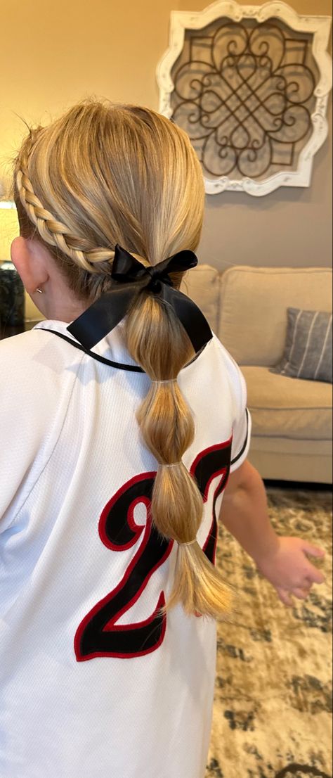 Softball Ribbon Hairstyles, Cheerleading Updos Cheer Hair, Hair For Tball Pictures, Toddler Girl Tball Hair, Girls Baseball Hairstyles, Softball Hair With Bow, Softball Hair With Ribbon, T Ball Hairstyles Kids, Softball Hairstyles For Picture Day