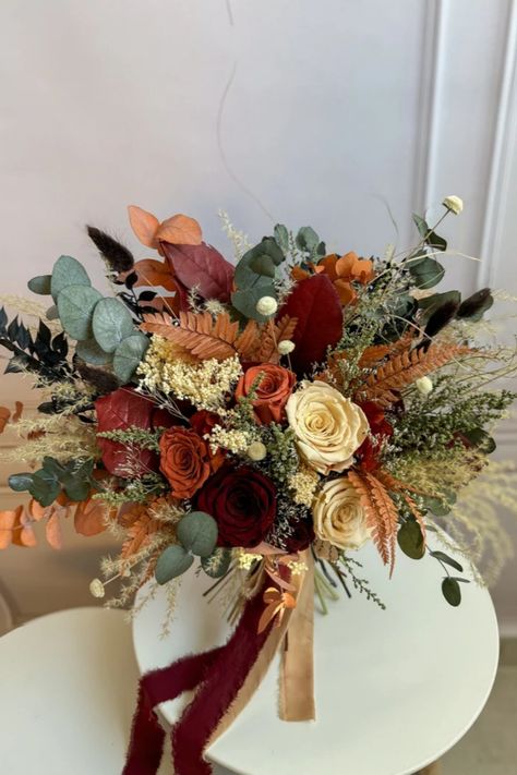 Immerse yourself in the warm elegance of autumn with this stunning greenery, marsala, and terracotta bouquet. A harmonious blend of deep Marsala tones, soft highlights, and lush greenery, this bouquet is thoughtfully crafted to perfectly enhance the charm of your rustic wedding celebration. Terracotta And Greenery Wedding Flowers, Earth Tone Bouquet, Terracotta Bridal Bouquet, Best Bouquet Flowers, Terracotta Bouquet, Best Bouquet, Soft Highlights, Flower Decoration Ideas, Bridesmaids Bouquet