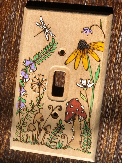 **This is a Made to Order item** Bring the natural world indoors with this sweet meadow design that has been burned into the wood. It is a lovely way to customize a room, whether your style is cottagecore, boho, farmhouse, eclectic, etc.  This light switch cover fits the standard single toggle light switch and includes brass-colored machine screws that blend beautifully with the color of the birch wood. The flowers, mushrooms, and dragonfly are painted and the rest is unfinished wood. The front Mermaid Light Switch Cover, Flower Light Switch Cover, Wood Burned Light Switch Cover, Cute Light Switch Art, Diy Light Switch Cover Ideas Paint, Clay Lightswitch Cover, Home Decor Cottagecore, Light Switch Painting Ideas Aesthetic, Boho Light Switch Cover