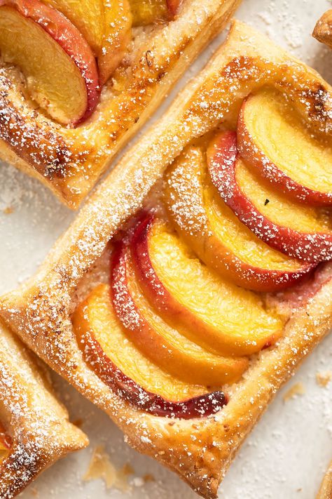 These peach puff pastry tarts are crispy, flaky, and full of flavor. With just five ingredients, they’re quick to make and ready to serve in about 30 minutes. Peach Recipes Puff Pastry, Peach With Puff Pastry, Peach Turnovers Pie Crust, Peach Tarts With Puff Pastry, Puff Pastry And Peaches, Fresh Peach Puff Pastry Recipes, Peach Danish Puff Pastries, Peach Tart Puff Pastry, Peach Pastry Recipes