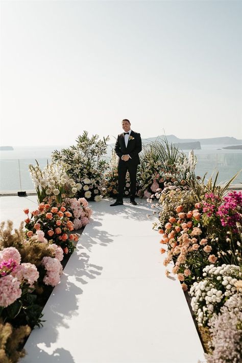 Opulent flower lined aisle for wedding ceremony in Mikonos, Greece | Image by Phosart Flower Lined Aisle, Aisle For Wedding, Weddings In Santorini, Best Wedding Suits, Altar Ideas, Greece Mykonos, Wedding Dress Boutiques, Santorini Wedding, Seaside Wedding