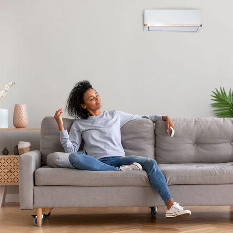 African young relaxed woman sitting on couch breathing fresh air Realistic Self Care, White Bedspreads, Sister Photos, Feel Good Stories, Sitting Poses, Let Your Hair Down, Human Poses Reference, Cozy Throw Blanket, Human Poses