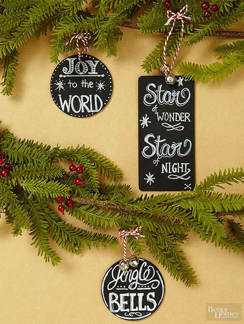 Your tree, your message. Pick a favorite carol lyric or holiday saying and write it on a chalkboard tag. To make, spray unfished wooden shapes with chalkboard paint, then use a pencil to lightly plan your design. Finish with a chalk pen, jingling bells, and red-and-white hanging loops. Chalkboard Ornaments, Chalkboard Sayings, Chalkboard Ornament, Chalkboard Christmas, Easy Ornaments, Easy Christmas Ornaments, Kids Christmas Ornaments, Easy Christmas Decorations, Navidad Diy