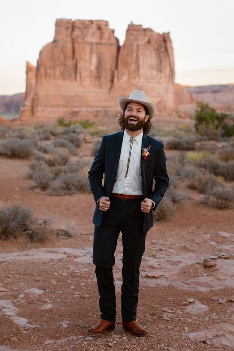 bolo tie, desert wedding, cowboy boots, moab elopement, blue suit, groom style, cowboy hat Suit With Cowboy Boots, Cowboy Wedding Attire, Wedding Outfits For Men, Boho Groom, Classic Boho Style, Cowboy Suit, Casual Groom Attire, Fall Wedding Outfits, Casual Grooms