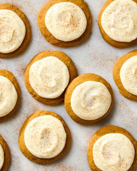 overhead shot of pumpkin spice cookies with cream cheese frosting on parchment paper Pumpkin Cookies With Cream Cheese Icing, Soft Pumpkin Cookie Recipe, Pumpkin Cookies Recipe, Pumpkin Spice Cookie Recipe, Autumn Drink, Pumpkin Cookies Healthy, Magical Food, Cookies With Cream Cheese Frosting, Cream Cheese Cookie Recipe