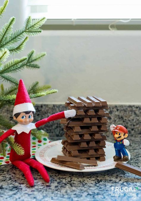 Create holiday magic with this fun Kit-Kat Jenga Idea for The Elf on the Shelf! Your Christmas elf plays Jenga using Kit-Kats with a favorite toy. Customize it to fit your child’s personality, and the next day, stage The Elf on the Shelf Chocolate Coma for more festive fun! New Ideas for Scout Elf  and free Christmas printbles. Last Day Elf Ideas, Elf On The Shelf Chocolate, Elf On A Shelf Ideas, Jenga Tower, Elf Printables, Kit Kat Bars, Elf On Shelf, The Elf On The Shelf, Elf Ideas