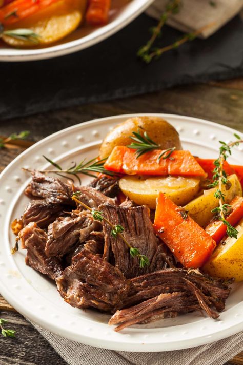 Chuck roast cooked in the oven as a pot roast and served shredded with vegetables on a plate Chuck Roast In Oven, Farm Meals, Roast In Oven, Shredded Beef Recipe, Slow Cooker Shredded Beef, Crockpot Pot Roast, Shredded Beef Recipes, Braised Chicken Breast, Potatoes And Carrots