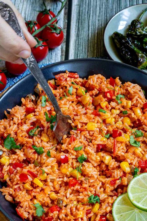 A Mexican-style dinner isn't Mexican-style without this fluffy and flavorful Mexican fried rice! This easy recipe comes together in just half an hour and is made with basmati rice, flavorful tomato puree, and various herbs, spices, and veggies. Serve it piping hot with lime wedges for an aromatic, flavor-packed side dish or entree that the whole family will love! Fried Rice Vegan, Mexican Fried Rice, Rice With Corn, Mexican Fries, Chili Rice, Mexican Rice Recipes, Mexican Side Dishes, Tomato Rice, Tomato Puree