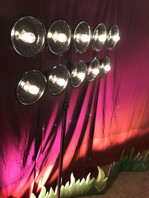 1x4, outdoor string lights, and spray-painted cereal bowls make great stadium lights! #vbs2018 #reachflorida Diy Stadium Lights Decorations, Stadium Lights Decoration, Diy Stadium Lights, Superbowl Decorations, Olympic Vbs, Football Backdrop, Sports Vbs, Dallas Cowboys Party, Sports Centerpieces