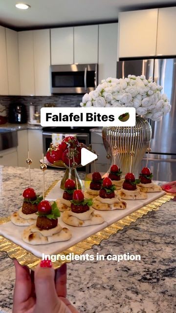 Reina G. Slim on Instagram: "On Fridays we make Falafel bites🤤🥙 What you will need 👇🏻  This is one of our favorite appetizer/snack around here. It’s the perfect appetizer for any occasion. Not only it’s so fun/easy to put together but soooo delicious and a crowd pleaser for sure! I’ve also made it with cucumber slices instead of the naan, sooo good! Try it out for your next gathering and thank me later😉  Ingredinets:  ▫️Mini Naan bread @stonefirenaan  ▫️Roasted garlic hummus or original ( I used roasted garlic)  ▫️Cherry tomatoes ( halved) ▫️Green leaf lettuce ( torn) ▫️Pickles ( sliced) ▫️Mini falafel balls ( Check Middle Eastern grocery stores or @traderjoes  ▫️Bamboo sticks   Now, it’s time to assemble. Scoop about 1 tsp hummus and place it on naan bread then using a bamboo stick s Mini Naan Appetizer, Mini Naan Bread Ideas Appetizers, Mini Naan Bread Appetizers, Naan Bread Appetizers, Crowd Pleaser Appetizers, Mini Naan, Make Falafel, Falafel Balls, Bread Roast