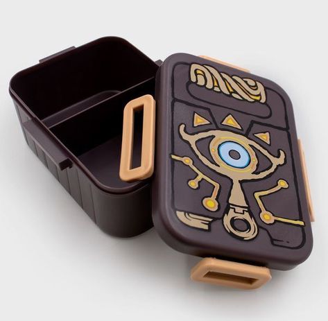 Officially Licensed Zelda Merchandise Designed After the Sheikah Slate Copy Paper Includes One Removable / Adjustable Divider Dimensions Approx: 7 5/8 Inches by 5 1/2 Inches BPA Free Dishwasher Safe Zelda Merchandise, Sheikah Slate, Zelda Gifts, Plague Mask, Gaming Merchandise, Zelda Breath Of The Wild, Zelda Breath, Copy Paper, Snack Box