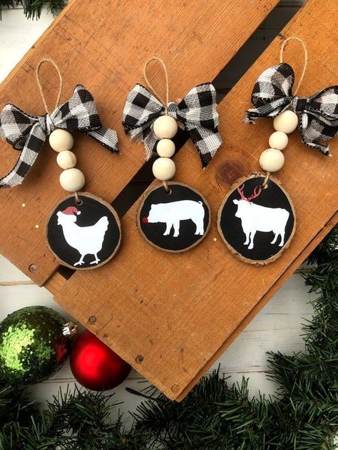 Looking for some easy and affordable ways to decorate your tree this season? Check out these DIY wood ornaments! They're perfect for any DIY enthusiast, and they're sure to add some character to your tree in a minimalistic and stylish way. Farm Animal Ornaments, Diy Wood Ornaments, Make Christmas Ornaments, Cow Ornaments, Farmhouse Christmas Ornaments, Christmas Crafts To Sell, Animal Ornaments, Wooden Christmas Decorations, Wood Slice Ornament