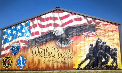 Muralist Sandra Pemberton, of Neosho MO, painted the 12’x20’ mural was painted in Sept 2021. Depicted in the mural, an American flag sweeps across the eaves above, arcing overtop a bald eagle whose wings are outstretched. At bottom right, the flag-raising soldiers from the Battle of Iwo Jima strike a bold silhouette before a glowing sunset. Beneath eneath the eagle, “We The People” is written. . At bottom left, a tribute to first responders and law enforcement. precise location unknown Patriotic Mural, Iwo Jima Flag Raising, Iwo Jima Flag, Battle Of Iwo Jima, Farm Building, Eagle Project, Patriotic Wall, American Flag Eagle, Iwo Jima