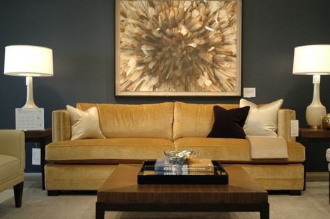 The gorgeous sofa and the rather unique painting on the wall have added plenty of charm to the decor of this room. Don't you think so? Gray And Navy Living Room, Brown And Gray Living Room, Gray And Brown Living Room, Navy Living Room Ideas, Gold Couch, Fall Color Trend, Gold Living Room Decor, Glam Living Room Decor, Gold Sofa