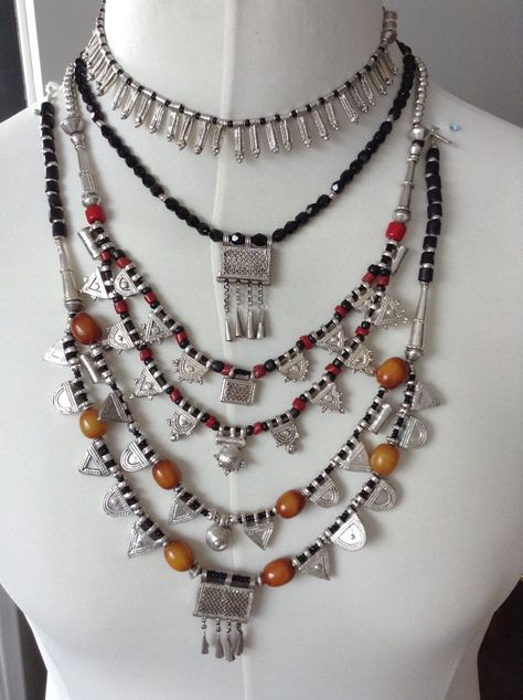 Picture credit – Ingrid Langerak Posted by – Ingrid Langerak A collection of East African necklaces. The top is an Eritrean fertility necklace, with anklet symbols. There are two necklaces with Ethiopian Wollo prayer boxes, and two necklaces with Wollo and Gondar good silver telsums, with old resin beads. One of these also has re-constituted red coral and black glass beads. Ethiopian Jewelry Traditional, Ethiopian Necklace, African Necklaces, African Inspired Jewelry, Ethiopian Clothing, Habesha Dress, Ethiopian Jewelry, Ethiopian Dress, Habesha Kemis