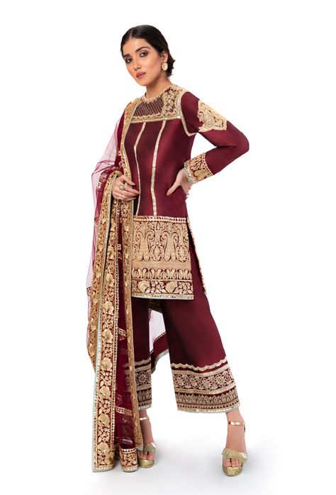 Maroon dupion silk kurta with gold tilla embroidery Paired with maroon dupion silk flared pants Comes with maroon net dupatta with badla embroidery This is a Three piece look. To customize, mail us at Manish Malhotra Suits, Manish Malhotra Dresses, Tilla Embroidery, Blue Sherwani, Trendy Outfits Indian, Pakistani Wedding Outfits, Custom Suits, Manish Malhotra, Silk Kurta