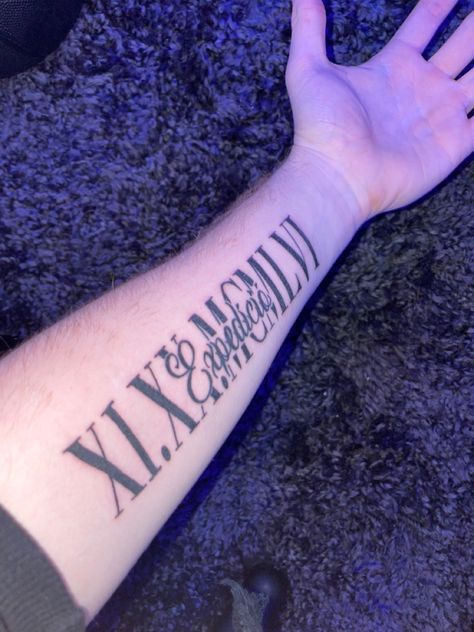 This tattoo is in dedication to my great grandparents. My great grandparents lived in Hungary during the Hungarian Revolution in 1956, and the roman numerals stand for the date that they left the country to travel around the get to a free country we call America. The word in the middle “Expedíció” means Expedition in Hungarian and shows the journey they had made to escape all the violence and to show how far they came to show their bravery and their courage to produce new life and new memories.. Forearm Roman Numeral Tattoo, Roman Numeral Tattoo Men Forearm, Colby Tattoo, Roman Numeral Tattoo Forearm, Name Tattoos For Men Forearm, 1973 Tattoo, Roman Numeral Tattoo Men, Roman Numeral Tattoo With Name, Tattoo Roman Numeral