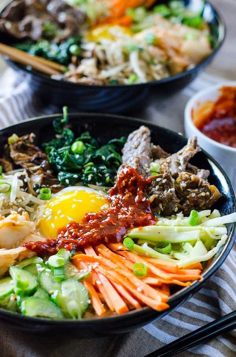 This Korean Bibimbap recipe is an Asian food lover's dream - a bowl full crispy rice, sautéed veggies, fried egg & some thinly sliced beef, drizzled with a spicy sauce. Bim Bop, Bulgogi Bibimbap, Korean Bibimbap, Bibimbap Recipe, Egg Recipes For Dinner, Sautéed Veggies, Bowl Meals, Eggs Dinner, Mouthwatering Food