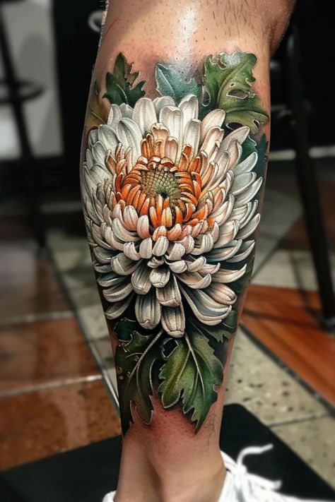 Detailed chrysanthemum flower tattoo with realistic shading on a person's calf. White Chrysanthemum Tattoo, Spidermum Flowers Tattoo, Chrysanthemum Flower Bouquets, Chrysanthemum Tattoo Sleeve, Floral Tattoo Ideas, Chyrasantemum Tattoo, Japanese Chrysanthemum Tattoo, Traditional Chrysanthemum Tattoo Design, Hydrangea Tattoo Sleeve