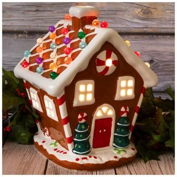 Dimensions: 10" H x 7.16" W x 7.48" D Power Source: Corded Electric Material: Ceramic & Glass Color: Brown, White, Red & Green Pattern: Stripes Care & Safety: Indoor Use Only Quantity: 1 Make your Christmas village display look brighter when you add this Light Up Gingerbread House! This charming ceramic house looks exactly like a gingerbread house, but without the frosting! Its colorful round spheres on top light up and give off a vibrant appearance. Simply turn on the lights to make your holida Up Gingerbread House, Christmas Fairy Lights, Gingerbread Village, Cookie House, Christmas Village Display, Berry Garland, Village Display, Christmas Decorations Diy Outdoor, Diy Christmas Decorations Easy