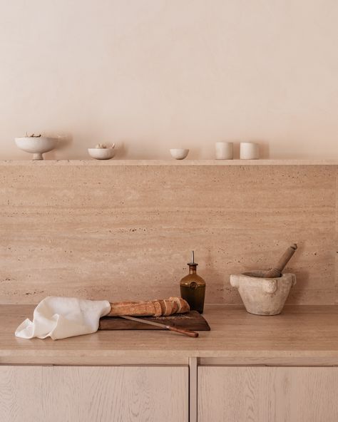 Kitchen glimpses at Can a Sol☀️ Travertine and oak with ceramics and linen 🤍 Lamps from @studioislas.lighting Photo @lifestyle_mallorca Travertine Kitchen Countertops, Kitchen Island With Table, Island With Table, Travertine Countertops, Limewash Walls, Lighting Photo, Kitchen Island Table, Travertine Stone, Stone Kitchen