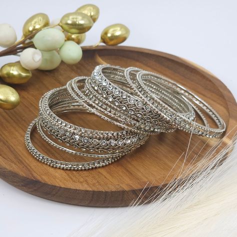 Adorn your wrists with this stunning silver polki bangle set.💫✨️ . . . . . . . . . #jewellery #goldbangles #bridaljewellery #jewellerytrends #pakistanijewellery #jewellerygifts #indianjewelleryuk #nacklaces #earrings #jewelry #bangleset #jhumkas #bangles #mathapatti #jutti #clutchbags #potlibagsforweddings #anklets #jhanjar #tikkaset #jewelleryoftheday #polkijewellery #mangtikka❤️ #jhumkabangles #goldbangles Silver Kangan, Bridal Things, Metal Bangles, Ear Chain, Antique Silver Jewelry, Bangles Set, Bangles Indian, Gold Plated Bangles, Head Chain