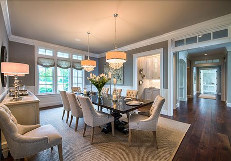 This neutral dining room is full of interest and beauty. Notice the transoms in the large hallway, the butler’s pantry and the double chandeliers above the dining table. Transitional Style Dining Room, Neutral Dining Room, Table With Chairs, Large Hallway, Transitional Dining Room, Transitional Dining, Neutral Interiors, Contemporary Dining Room, Elegant Furniture