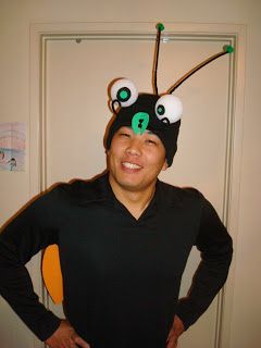 Easy bug costume. She started with a plain black beanie and added styrofoam ball eyes and pipe cleaner antennae with little green pom poms on the end.  Also made insect wings. Otherwise dressed in black.  Cute simple idea that gives the person a lot of freedom and mobility. Bug Costume Diy, Bee Costume Diy, Fly Costume, Firefly Costume, Adult Princess Costume, Homemade Mermaid Costumes, Native American Halloween Costume, Bug Costume, Girl Group Costumes