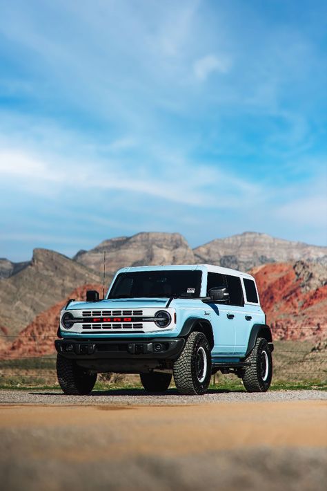 2023 Ford Bronco Heritage Edition in Robins Egg Blue Parked On A Dirt Road During The Day With Red Rock Mountains In The Background. Blue Ford Bronco Aesthetic, Blue Bronco Aesthetic, Outer Banks Bronco, Bronco Ford 2023, Bronco Wallpaper Iphone, Ford Bronco Heritage Edition, Light Blue Bronco, Baby Blue Bronco, Ford Bronco 2023