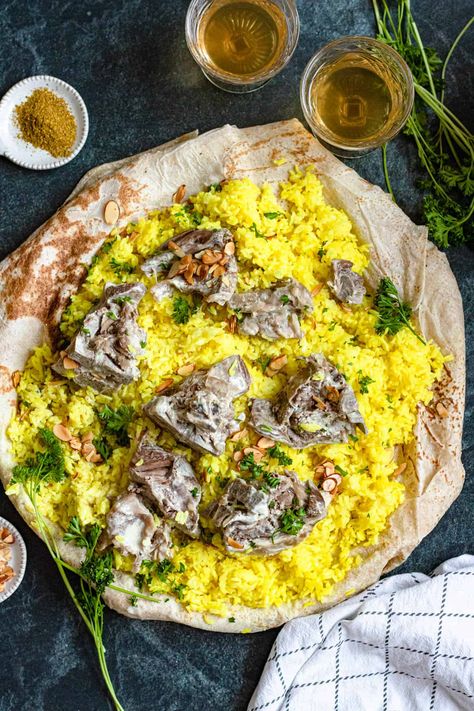 Mansaf is a traditional Jordanian meal made of lamb and rice, seasoned with a unique yogurt sauce. For an authentic taste of Jordan, this recipe is a must-try! Jordan Food Recipes, Jordanian Food Recipes, Mansaf Jordan, Jordanian Mansaf, Mansaf Recipe, Jordanian Recipes, Lamb And Rice, Jordanian Food, Arabic Dishes