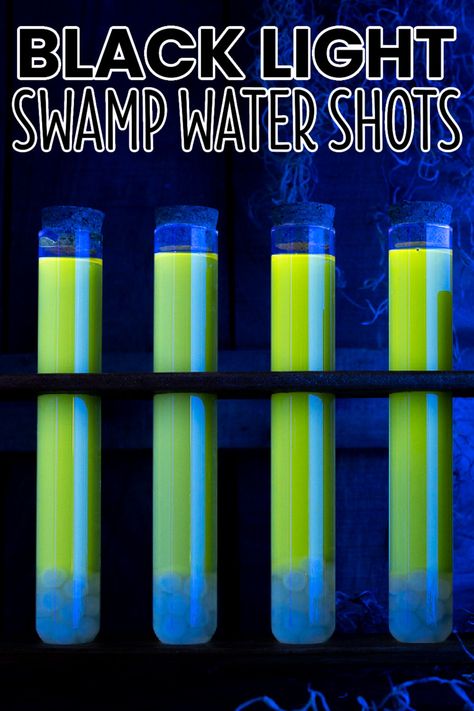 So creepy and delicious, Black Light Swamp Water Shots are a darkly glowing, spooky drink to serve all undead guests and a few witches too! #BreadBoozeBacon #testtube #shots #testtubeshots #strawberry #lemon #rum #cocktail #halloween #halloweencocktails #halloweenparty Test Tube Shots Halloween, Halloween Boba Drink, Halloween Shots Recipes, Light Alcoholic Drinks, Halloween Shooters, Zombie Drink, Fruity Shots, Test Tube Shots, Malibu Cocktails