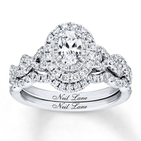 Neil Lane Bridal® rings feature modern, vintage-inspired designs that celebrate Hollywood glamour. This engagement ring showcases a 1/2 carat oval diamond as the brilliant center of attention. Sparkling round diamonds encircle the center and beautifully decorate the band of 14K white gold. Additional round diamonds line the matching contoured wedding band. The bridal set has a total diamond weight of 1 1/3 carats. Diamond Total Carat Weight may range from 1.29 - 1.36 carats. Neil Lane Bridal Set, Bridal Diamond Ring, Neil Lane Engagement Rings, Neil Lane, Vintage Style Engagement Rings, Braut Make-up, Bridal Engagement Rings, Bridesmaid Jewelry Sets, Diamond Bridal Sets