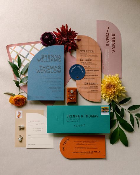 Wedding flat lay with uniquely shaped invitations. Hues of blue, turquoise, persimmon, and apricot are elevated with loose flower buds. Funky Wedding Color Palette, Wedding Invite Unique, Retro Eclectic Wedding, Funky Fall Wedding, Mid Century Modern Wedding Invitations, Colorful Wedding Stationery, Fall Eclectic Wedding, Funky Wedding Invites, Colorful Save The Date