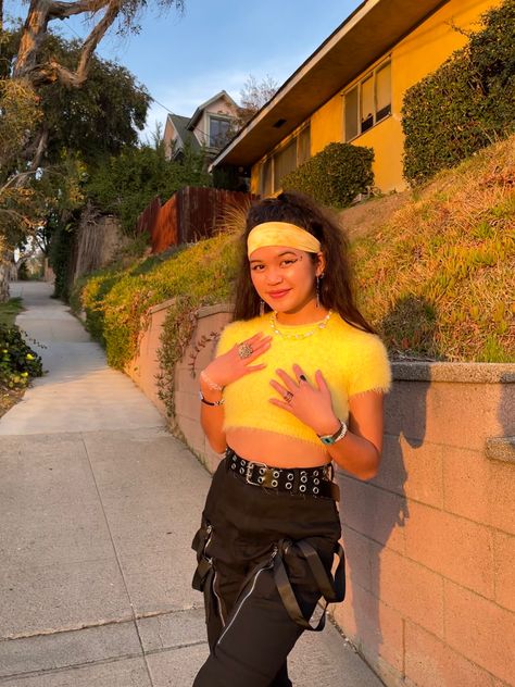 Streetwear, fashion, girl, women, outfit, outfits, girl, aesthetic, Los Angeles style, for school, LA, winter, spring, summer, fall, trendy, style, ootd, for girls, inspo, clothing, clothes, yellow, mohair, fuzzy, crop top, black cargo pants, strappy pants, headband, high ponytail, rings, golden hour, stamp liner, necklace, jewelry Yellow Top Black Pants Outfit, Black And Yellow Rave Outfit, Yellow Rave Outfit, Streetwear Fashion Girl, Yellow Crop Top Outfit, Aesthetic Los Angeles, Style For School, Fuzzy Crop Top, Twenty One Pilots Concert