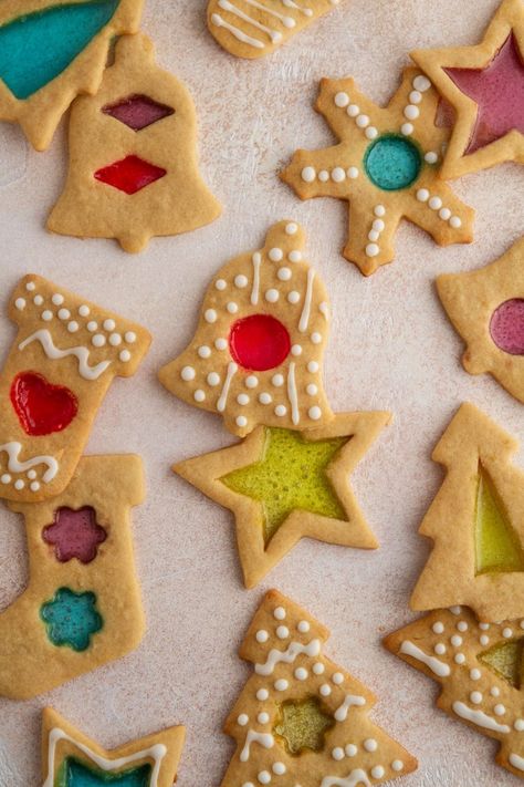 hese Stained Glass Window Cookies are both stunning and simple: the perfect combination. A super-forgiving sugar cookie dough with a kiss of molasses is baked with centers of crushed candies and decorated with icing for a fun, festive and straightforward cookie recipe you'll want to bake year after year. Stained Glass Cookies Jolly Rancher, Stained Glass Sugar Cookies, Glass Window Cookies, Colorful Cookies, Window Cookies, Stained Glass Cookies, Iced Sugar Cookies, Sugar Cookie Dough, Star Cookies