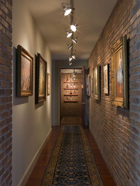 industrial hallway with artworks that are highlighted with track lights Industrial Hallway, Bright Hallway, Hallway Gallery Wall, Vstupná Hala, Blitz Design, Interior Design Hallway, Stone Walls Interior, Small Foyer, Interior Brick