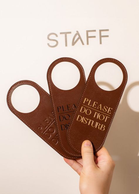 Refine your guests' privacy with our Do Not Disturb Door Sign. This custom door sign, perfect for hotels, features a stylish, minimalist design that complements any interior. The hotel room sign is made from two layers of thick Italian leather and is available in various colors to suit your aesthetic needs. Hotel Door Hanger, Do Not Disturb Door Sign, Hotel Hanger, Hotel Door, Do Not Disturb, Custom Door, Room Signs, Hotel Design, Door Sign